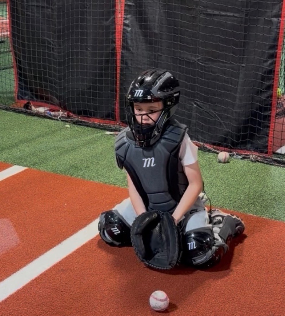 Young catcher in gear during training